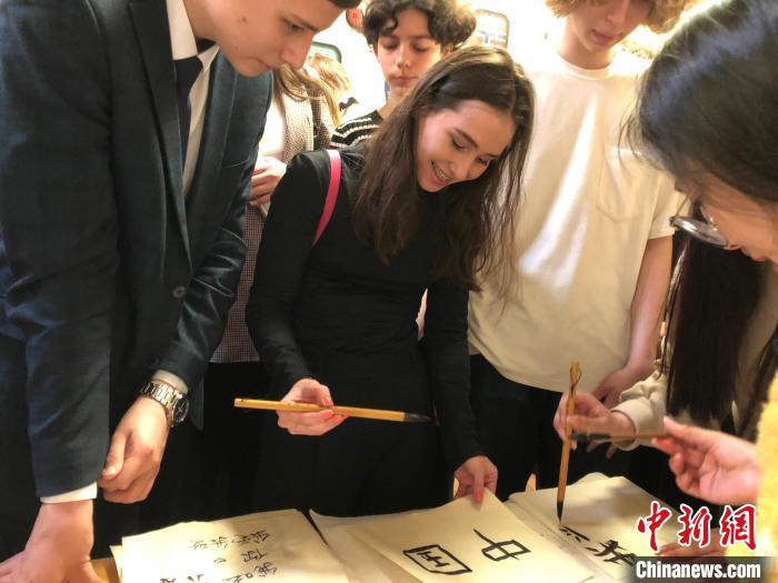 4月21日，莫斯科國立語言大學(xué)孔子學(xué)院附屬中學(xué)舉辦“國際中文日”活動，學(xué)生們學(xué)寫漢字?！∧箍茋⒄Z言大學(xué)孔子學(xué)院 供圖