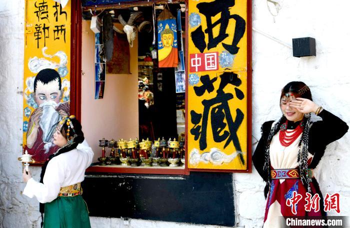 4月17日，游客身著藏式元素服裝在拉薩八廓街拍照留念?！±盍?攝