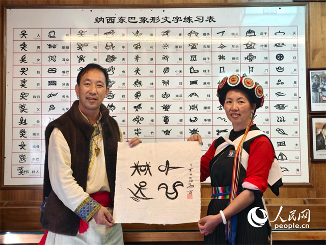 人民網(wǎng)“行進(jìn)中國(guó)”云南調(diào)研采訪團(tuán)走進(jìn)麗江，和閏元現(xiàn)場(chǎng)用東巴文寫下“行進(jìn)中國(guó)”。人民網(wǎng)記者 符皓攝