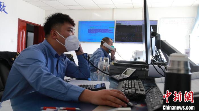 圖為貨運(yùn)調(diào)度人員與外勤工作人員聯(lián)系掌握車輛裝載情況?！±钌?攝