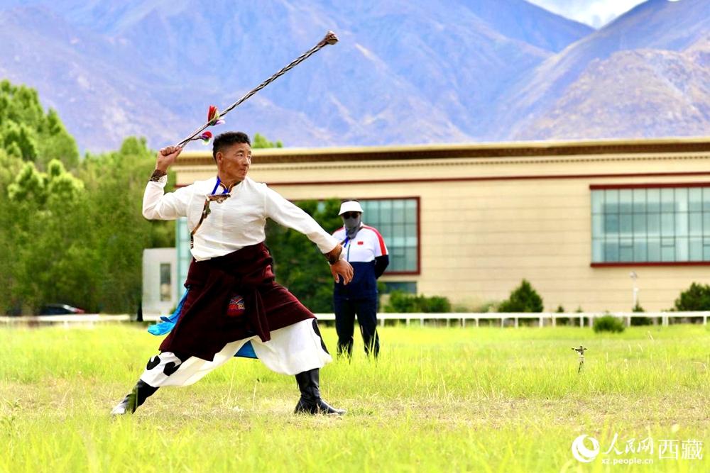 參賽選手在拉薩首屆農(nóng)牧民運(yùn)動(dòng)會(huì)上進(jìn)行“古朵”比賽（“古朵”指的是用牦牛毛或者山羊毛編織成的拋石繩，可以將石頭投擲到較遠(yuǎn)的地方，是牧民們用來放牧的工具）。